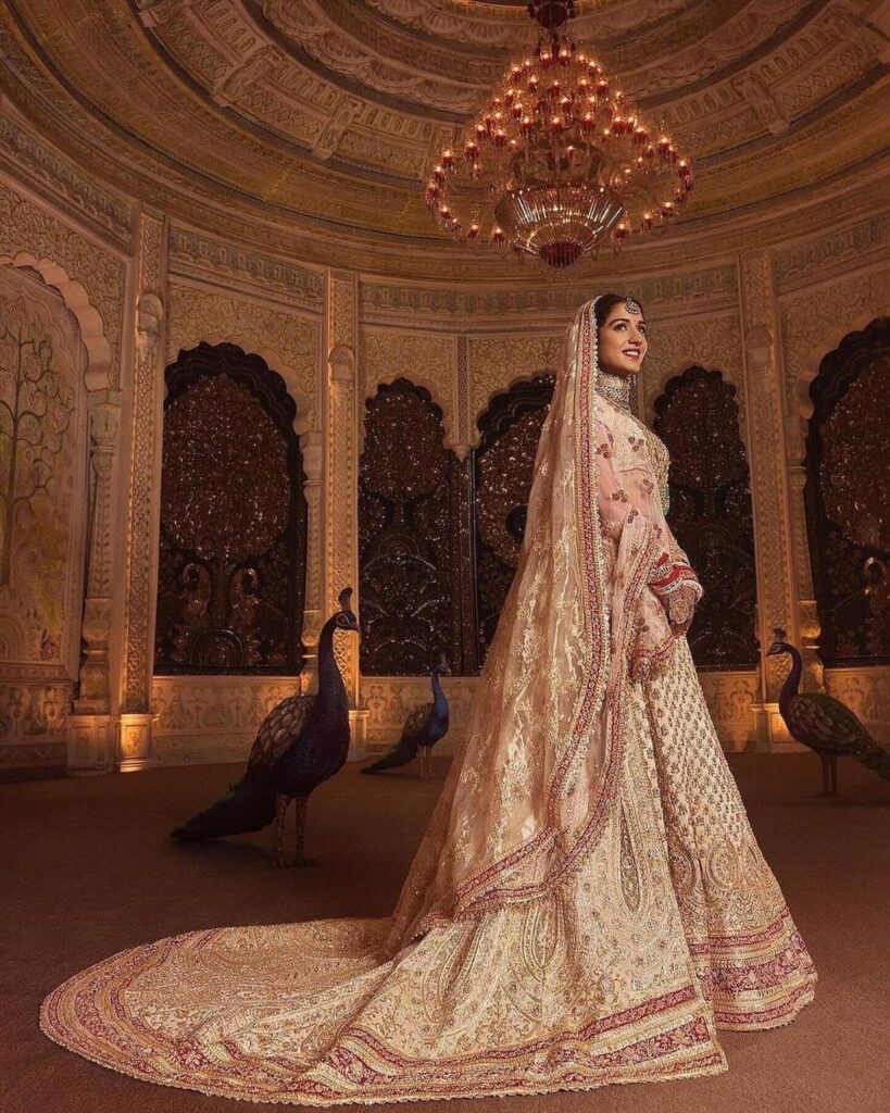 Radhika Merchant wearing a white and gold bridal Panetar lehenga with a long trail